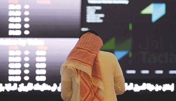 A Saudi investor monitors share prices at the Saudi Stock Exchange, or Tadawul, in the capital Riyadh. The listing will value ACWA at up to $11bn.