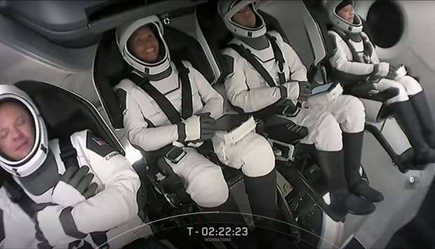 This screengrab taken from the SpaceX live webcast shows crew members after being buckled into their seats in the Crew Dragon capsule ahead of the launch of the Inspiration4 at NASA's Kennedy Space Center in Florida, on September 15, 2021.