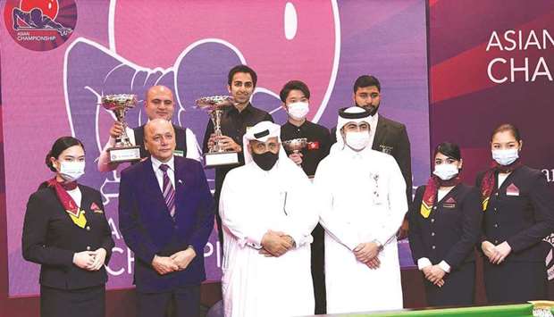 Indiau2019s Pankaj Advani (top second left) celebrates on the podium with other winners and officials after winning the Asian Snooker title at the Al Messila Luxury Resort in Doha yesterday.