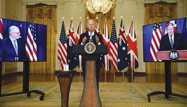 Biden participates is a virtual press conference on national security with British Prime Minister Boris Johnson and Australian Prime Minister Scott Morrison in the East Room of the White House in Washington, DC.