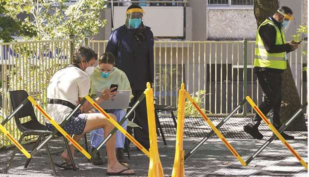 A health worker speaks with a member of the public at a coronavirus vaccination clinic set up for residents of surrounding public housing towers in the Redfern suburb, where authorities are working to contain an emerging cluster of cases, as widespread lockdown continues in Sydney.
