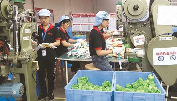 (File photo) Employees work on the production line of American infant product and toy manufacturer Kids II Inc at a factory in Jiujiang, Jiangxi province, China, recently. (Reuters)