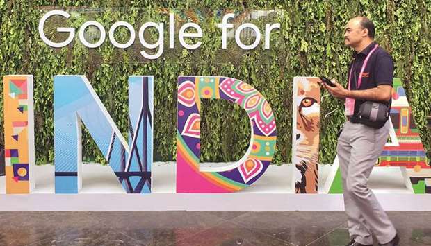 A man walks past the sign of u201cGoogle for Indiau201d, the companyu2019s annual technology event in New Delhi (file). Indiau2019s antitrust body has found Google leverages its dominance in the Android mobile operating system and related markets with anti-competitive and restrictive trade practices, a local news report said.