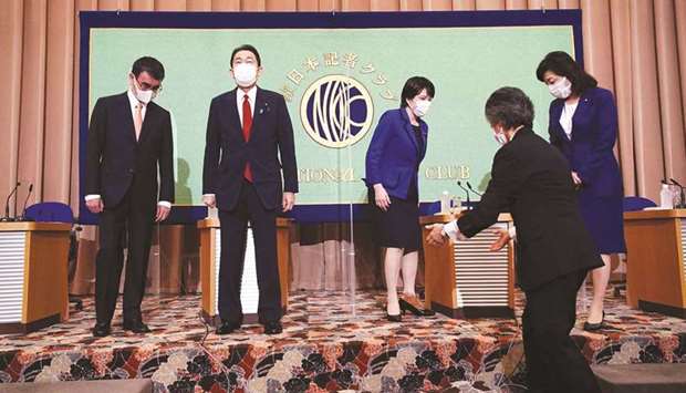 Candidates for the presidential election of the ruling Liberal Democratic Party, (from left) Taro Kono, the cabinet minister in charge of vaccinations; Fumio Kishida, former foreign minister; Sanae Takaichi, former internal affairs minister; and Seiko Noda, former internal affairs minister; take their places as they pose for photographers prior to a debate session at the Japan National Press club in Tokyo yesterday.