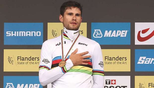 Italyu2019s Filippo Ganna celebrates with his medal on the podium after winning the menu2019s Elite Individual Time Trial title at the UCI Road World Championships in Bruges, Belgium, yesterday. (Reuters)