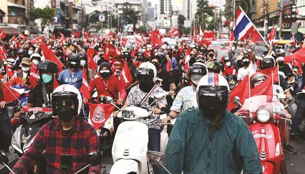 Anti-government protesters gather for a demonstration on scooters to mark the 15-year anniversary since the 2006 military takeover in Bangkok yesterday.