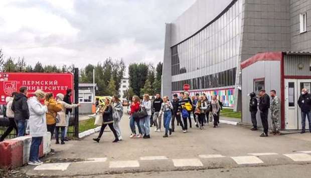 Students evacuate a building of the Perm university campus in Perm on September 20, 2021 following a shooting.