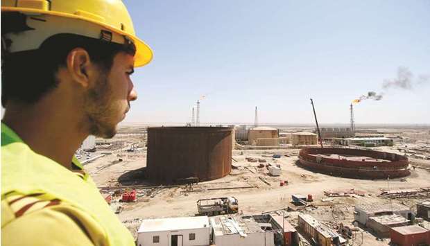 An Iraqi worker looks at the Al-Shuaiba oil refinery in southwest Basra (file). Iraq warned that oil demand will probably rise as the supply crunch in natural gas markets forces consumers to look for alternative fuels, echoing the views of fellow Opec member Nigeria.