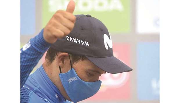 Team Movistaru2019s Colombian rider Miguel Angel Lopez celebrates on the podium after winning the 18th stage of the La Vuelta in Altu du2019El Gamoniteiru in Pola de Lena, Spain, yesterday. (AFP)
