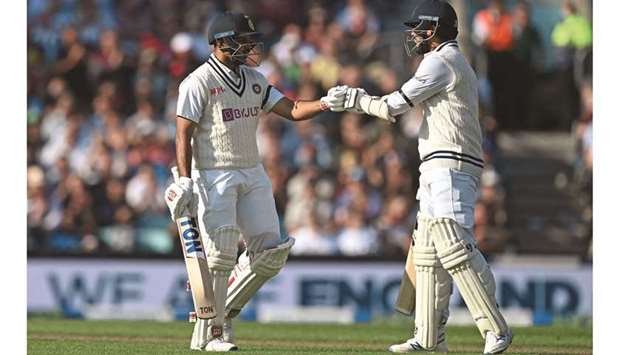 Indiau2019s Shardul Thakur (left) is congratulated by Indiau2019s Umesh Yadav after reaching 50 at the Oval during the first day of the fourth Test against England in London yesterday. (AFP)
