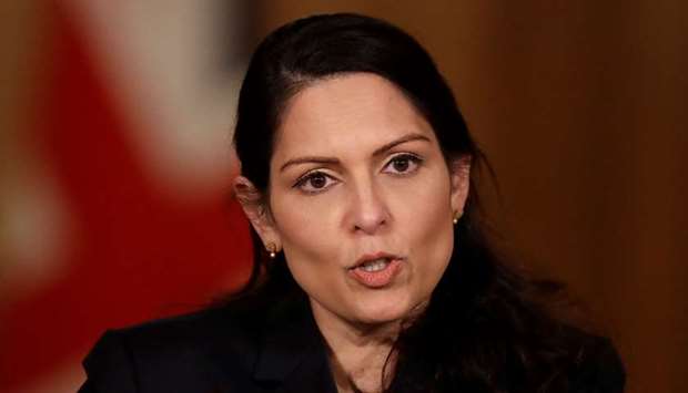 Britain's interior minister Priti Patel has said the current system was ,overwhelmed,.