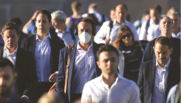 Workers walk towards the City of London financial district as they cross London Bridge during the morning rush hour in London. The Bank of England said the case for higher interest rates u201cappeared to have strengthenedu201d on Thursday after it nudged up its forecast for inflation at the end of the year to over 4%, more than twice its target rate.