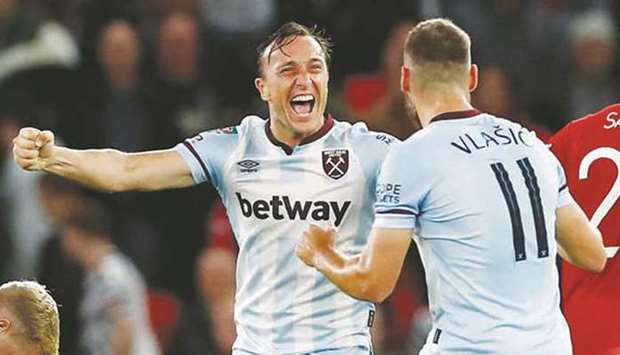 West Ham Unitedu2019s Mark Noble (left) celebrates with Nikola  Vlasic after victory over  Manchester United in the League Cup. (Reuters)