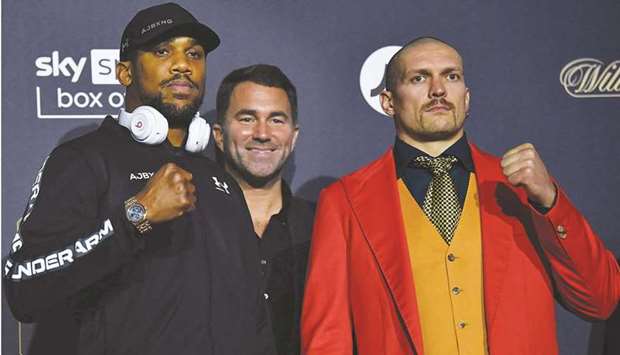 British heavyweight champion boxer Anthony Joshua (left) and Ukraineu2019s Oleksandr Usyk during a press conference at Tottenham Hotspur Stadium in London yesterday. (AFP)