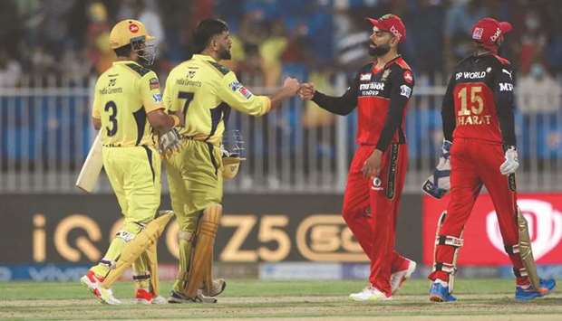 Chennai Super Kingsu2019 captain Mahendra Singh Dhoni (second from left) and Suresh Raina (left) celebrate their victory in the IPL match against the Royal Challengers Bangalore at the Sharjah Cricket Stadium in the United Arab Emirates yesterday. (Sportzpics for IPL)