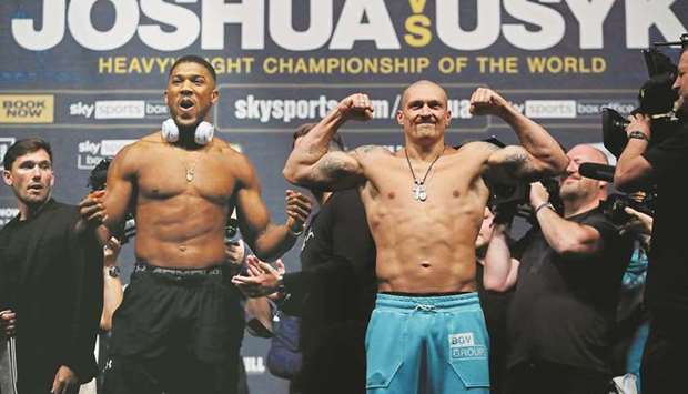 Anthony Joshua (left) and Oleksandr Usyk during the weigh-in at the The O2 Arena in London yesterday. (Reuters)