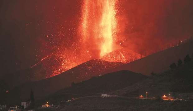 The Cumbre Vieja volcano in El Paso spews lava on Thursday night, as seen from Los Llanos de Aridane, on the Canary island of La Palma.