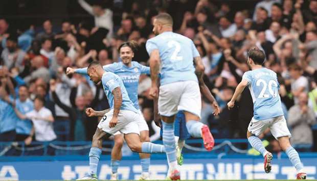 Manchester Cityu2019s Gabriel Jesus (left) celebrates with teammates after scoring against Chelsea during the English Premier League match at the Stamford Bridge in London yesterday. (Reuters)
