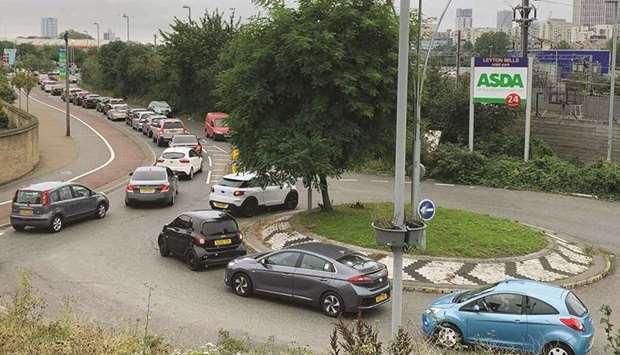 An aerial view shows customers queueing in their cars to access an Asda petrol station in east London.