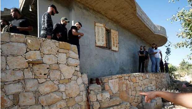 People check the scene where three Palestinians were killed by Israeli forces during a raid, in Beit Anan in the Israeli-occupied West Bank. REUTERS
