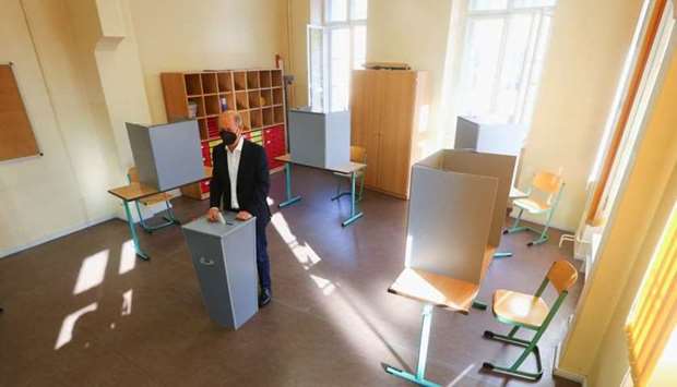 Olaf Scholz, Social Democratic Party (SPD) candidate for chancellor, wearing a protective face mask, casts his vote in the general election, in Potsdam, Germany. REUTERS