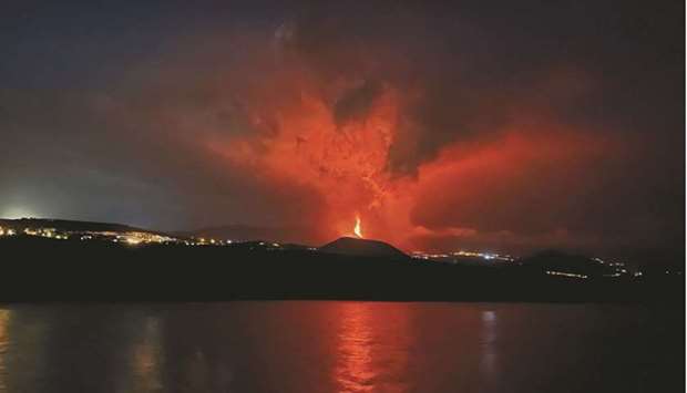 Lava and smoke rise from an erupting volcano in the Cumbre Vieja national park at Tazacorte, on the Canary Island of La Palma.