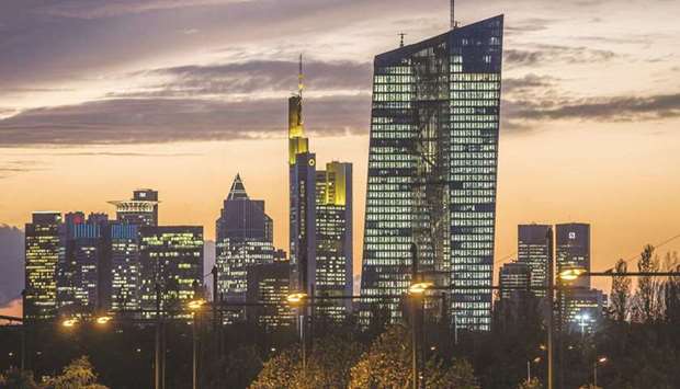 The European Central Bank building (right) is illuminated while dominating the skyline of Frankfurt (file). The ECB has pushed back against suggestions of a taper and one official even raised the prospect of increasing its regular asset purchases once it ends its pandemic programme.