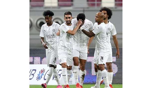 Al Sadd players celebrate after scoring a goal against Al Shamal.