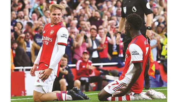 Arsenalu2019s Emile Smith Rowe (left) celebrates with Bukayo Saka after scoring against Tottenham Hotspur in London yesterday. (Reuters)