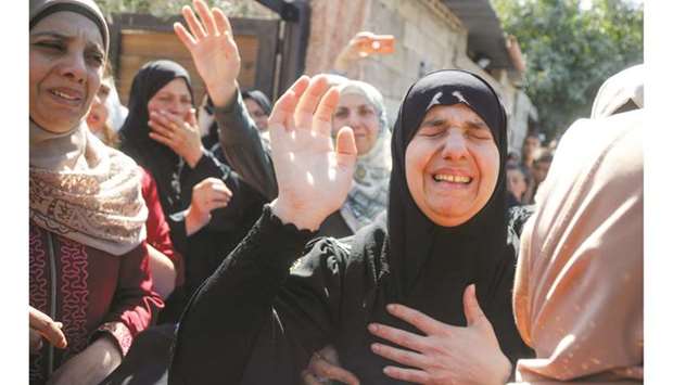 Mother of Palestinian Osama Soboh, who was killed by Israeli forces during clashes in a raid, mourns during his funeral in Burqin in the occupied West Bank, yesterday.