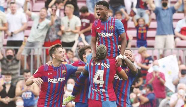 Barcelonau2019s Ansu Fati celebrates scoring their third goal with teammates against Levante at the Camp Nou in Barcelona yesterday. (Reuters)