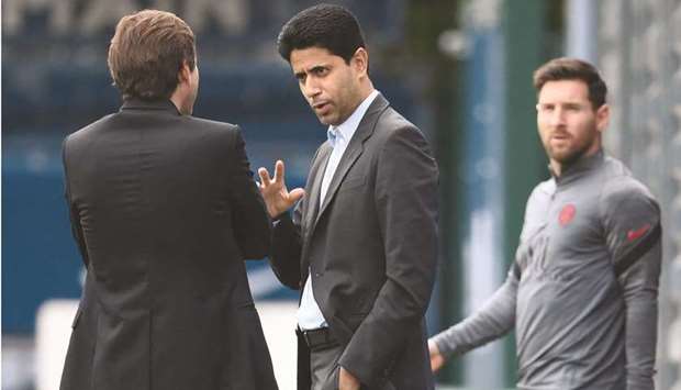 PSGu2019s president Nasser al-Khelaifi talks to clubu2019s sporting director Leonardo (left) as Argentinian forward Lionel Messi (right) arrives for a training session at the clubu2019s Camp des Loges training ground in Saint-Germain-en-Laye, France, yesterday. (AFP)