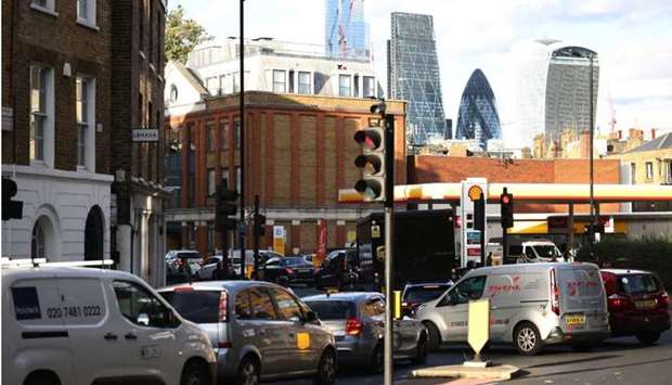Vehicles queue to refill at a Shell fuel station in central London, Britain yesterday. REUTERS