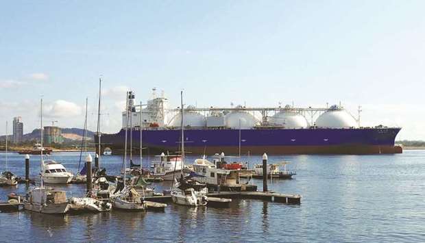 An LNG tanker passes boats along the coast of Singapore (file). Asian spot LNG prices are set to spike further this winter and may break previous records set last winter as inventory levels remain low and producers are yet to ramp up supply, executives said on Tuesday.