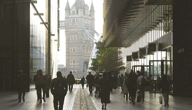 Workers walk towards Tower Bridge in London. More than 1mn British workers face an uncertain future this week as the UK becomes the worldu2019s first big economy to wind up its Covid-19 jobs support scheme.
