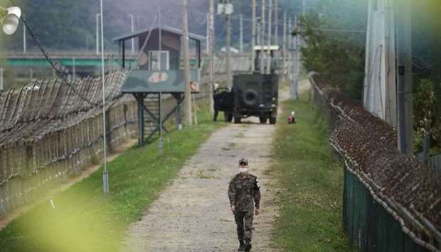 A South Korean soldier walks along a military fence near the demilitarized zone separating the two Koreas in Paju, South Korea, September 28. REUTERS