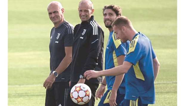 (From right) Juventusu2019 forward Dejan Kulusevski, midfielder Manuel Locatelli and head coach Massimiliano Allegri attend a training session at the Continassa training ground in Turin yesterday. (AFP)
