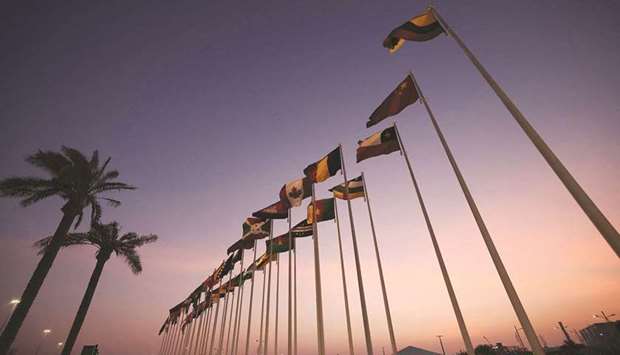 The national flags of countries participating in the Expo 2020 are lined up at the entrance of the venue yesterday.