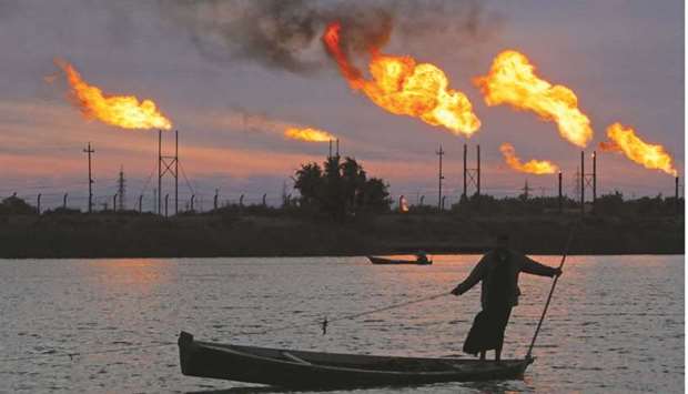 Flames emerge from flare stacks at the oil fields in Basra (file). Opec lifted output by 290,000 barrels a day in August, slightly more than stipulated by its road map for restoring output, according to a Bloomberg survey. Saudi Arabia and Iraq were the main drivers of the increase.