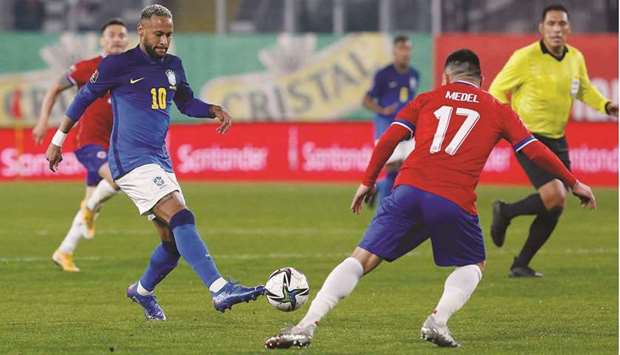 Brazilu2019s Neymar (left) in action with Chileu2019s Gary Medel during the World Cup qualifier match at Estadio Monumental David Arellano in Santiago, Chile, yesterday. (Reuters)