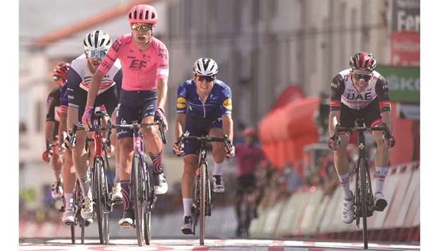 First-placed EF Educationu2019s Danish rider Magnus Cort Nielsen (second from left) crosses the finish line followed by Team UAE Emiratesu2019 Portuguese rider Rui Oliveira (right) and third-placed Team Treku2019s US rider Quinn Simmons (left) during the 19th stage of the La Vuelta in Monforte de Lemos, Spain, yesterday. (AFP)