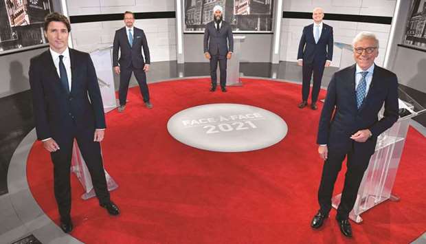 Trudeau (left), Blanchet (second left), Singh (centre), Ou2019Toole (2R) and Canadian journalist Pierre Bruneau (right) pose for the official photo at the TVA studios ahead of the Face-a-Face 2021 debate in Montreal on Thursday evening.