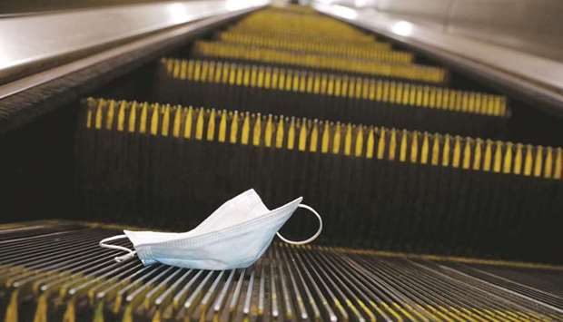A protective mask is seen discarded on an escalator during the outbreak of the coronavirus disease (Covid-19) pandemic in Manhattan, New York City.