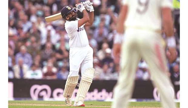 Indiau2019s Rohit Sharma brings up his century with a six off Moeen Ali (not in the picture) on the third day of the fourth Test against England at the Oval cricket ground in London yesterday. (AFP)