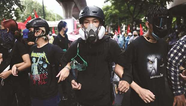 Anti-government protesters wearing protective gear take part in a demonstration in Bangkok.