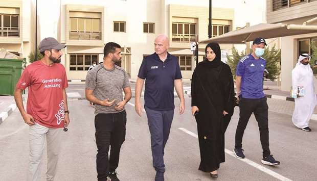 FIFA President Gianni Infantino (centre) visits a Qatar 2022 residential compound currently hosting Afghan evacuees with HE the Assistant Minister of Foreign Affairs and Spokesperson for the Ministry of Foreign Affairs Lolwah bint Rashid AlKhater and Supreme Committee of Delivery & Legacy (SC) Secretary-General HE Hassan al-Thawadi.