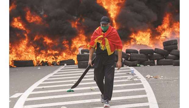 A man walks past a barricade on a road to the city of Cetinje, during a protest in Montenegro (see report on the left).