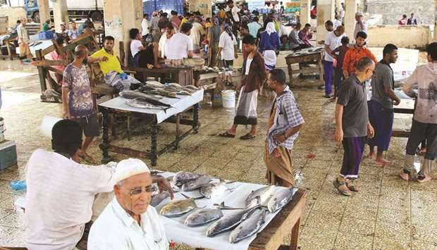Vendors wait for customers at a fish market in Aden, Yemen.