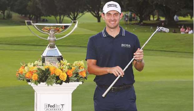 Patrick Cantlay of the United States celebrates with the FedEx Cup and Calamity Jane putter trophy after winning the final round of the Tour Championship at East Lake Golf Club in Atlanta. (Getty Images/AFP)