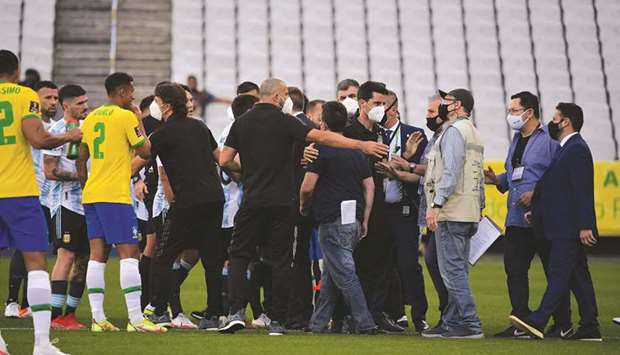Employees of the National Health Surveillance Agency (Anvisa) enter the field during the South American qualification match for the FIFA World Cup Qatar 2022 between Brazil and Argentina at the Neo Quimica Arena in Sao Paulo, Brazil, on Sunday. (AFP)